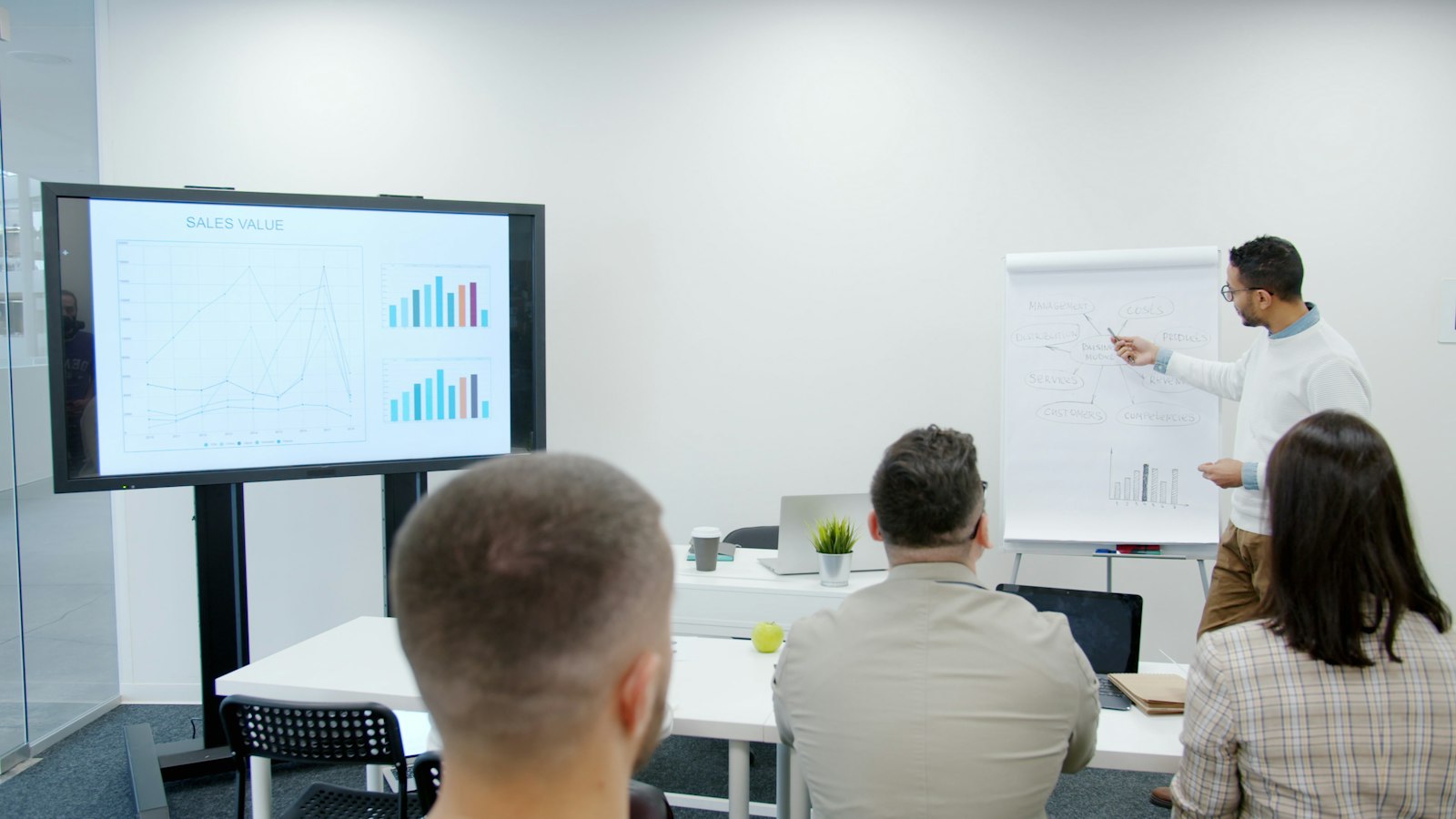 Trainer presenting charts to a seated audience